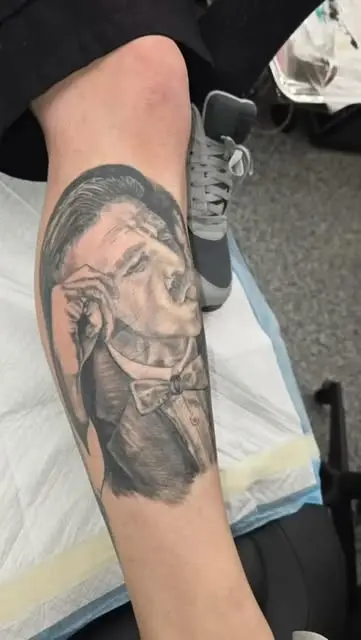 Black and grey portrait of a man in a top hat on a calf