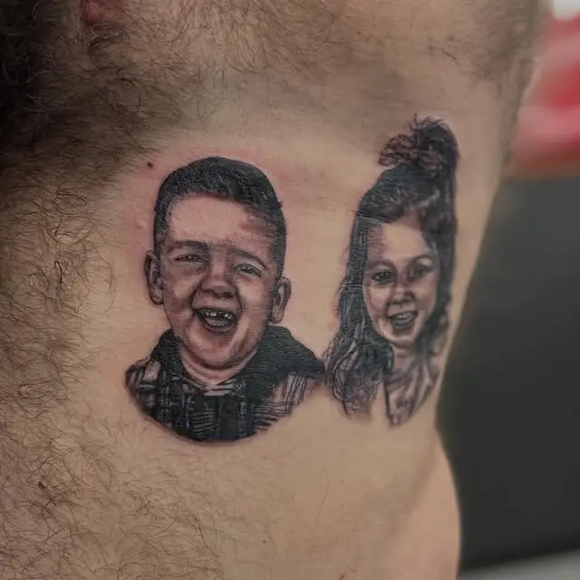 Black and grey portrait tattoo of two laughing children